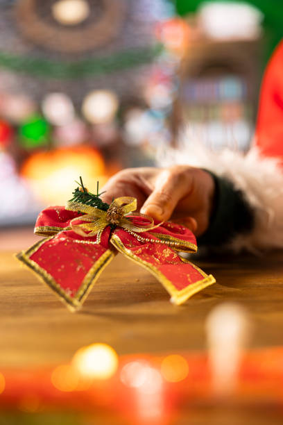 istock Santa Claus packs a gift box in his workshop surrounded by festive decorations 2184637479