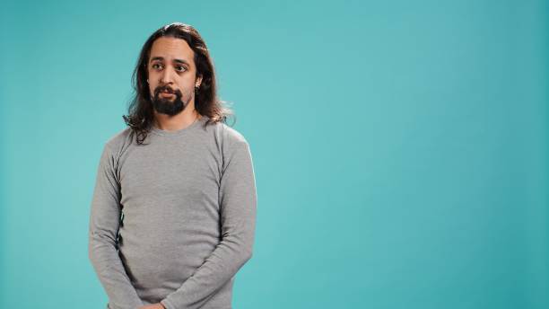 istock Portrait of spiteful man making exaggerated silly faces, mimicking someone 2184637678