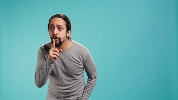 istock Portrait of man doing shushing hand gesturing, requesting silence 2184638025