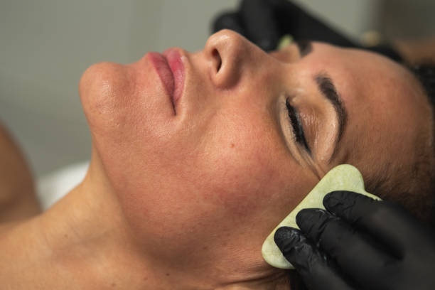 istock facial massage, beauty trend. gua sha 2184638712