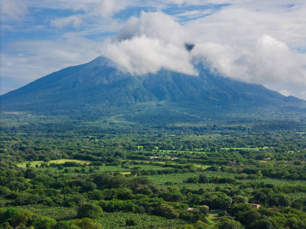 istock Lush green landscape beneath a majestic volcano 2184640474