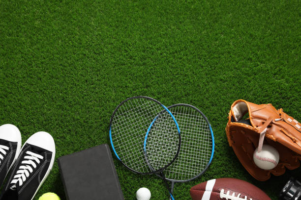 istock Different sports equipment on green grass, flat lay. Space for text 2184640609