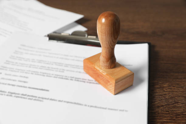 istock Documents and stamp on wooden table, closeup. Notary contract 2184640647