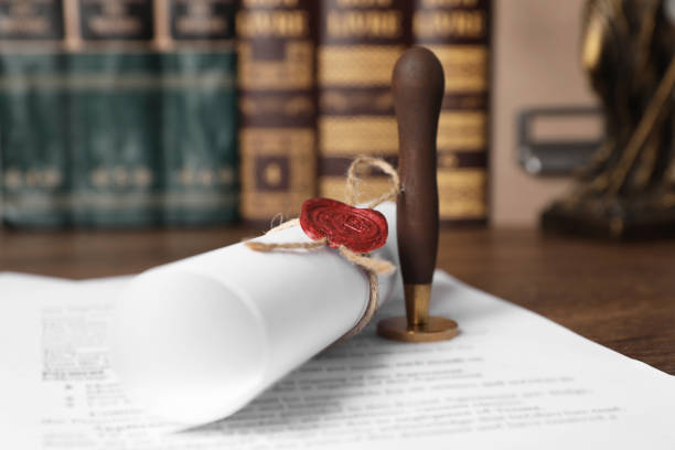 Documents and stamp on wooden table, closeup. Notary contract