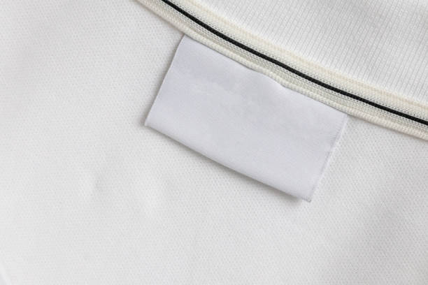istock Blank white laundry care clothes label on white shirt fabric texture background 2184645320
