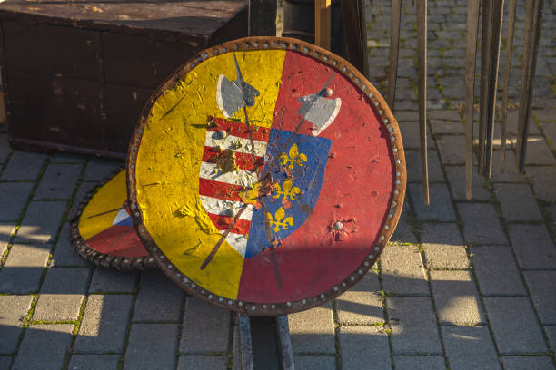 Mid-adult Caucasian man, wearing the warrior costume, shield and spear, at nature during winter