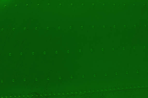 Metal plating of military equipment with rivets. Green Surface of a metal wall with rivets.