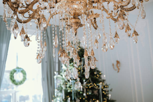 istock Elegant chandelier adorned with crystals hanging above a festive Christmas tree 2184646847