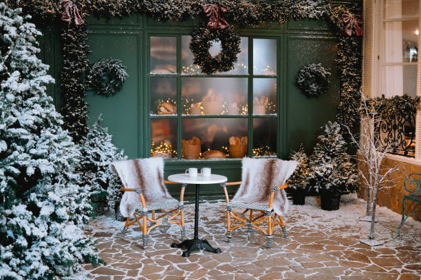 istock Cozy winter patio with snowy decorations and warm seating for two 2184646848