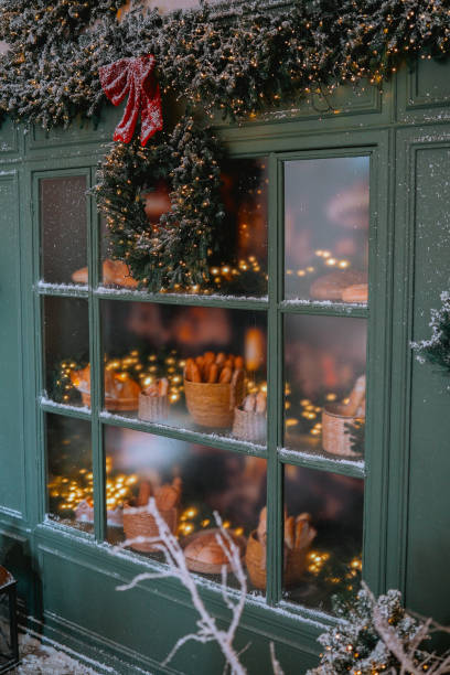 istock Cozy bakery window decorated for winter with festive lights and treats 2184646854