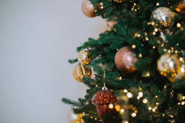 istock Decorated Christmas tree with ornaments and lights in a cozy indoor setting 2184646864