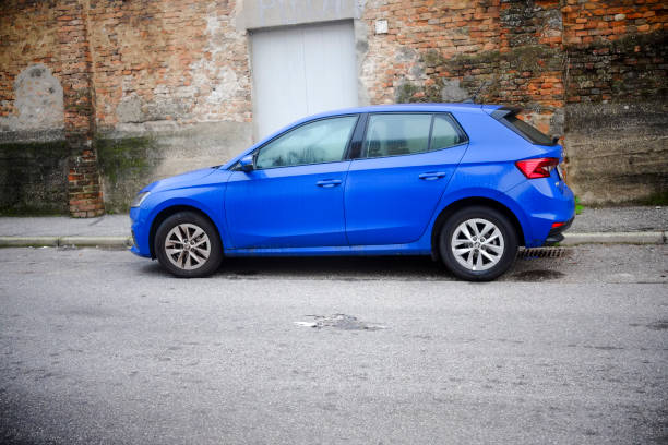 Cremona, Lombardy, Italy - November 7th 2024 Modern compact car parked near an old brick wall, showcasing urban parking challenges and automotive design