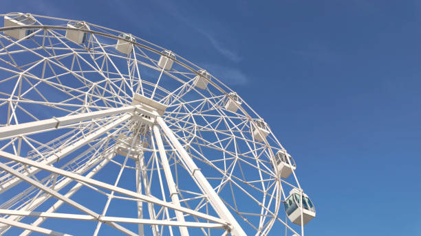 istock White ferris wheel against a clear blue sky 2184647605