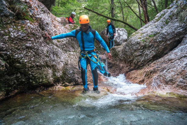 istock Black Male Canyoning in Neoprene Suits and Helmets 2184648151