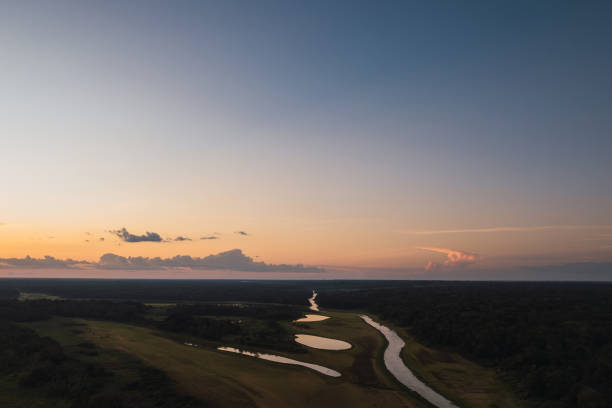 istock Sunset over winding river and wetlands in the Amazon rainforest 2184654635