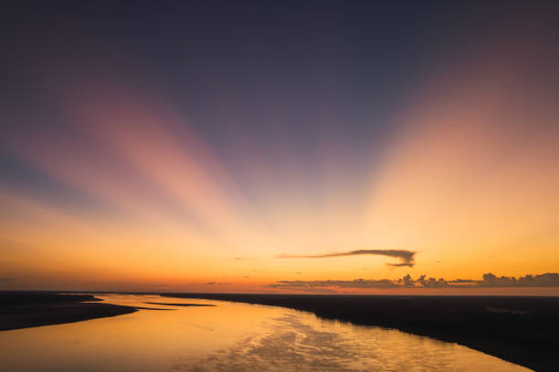Radiant sunset with sunbeams over the Amazon River