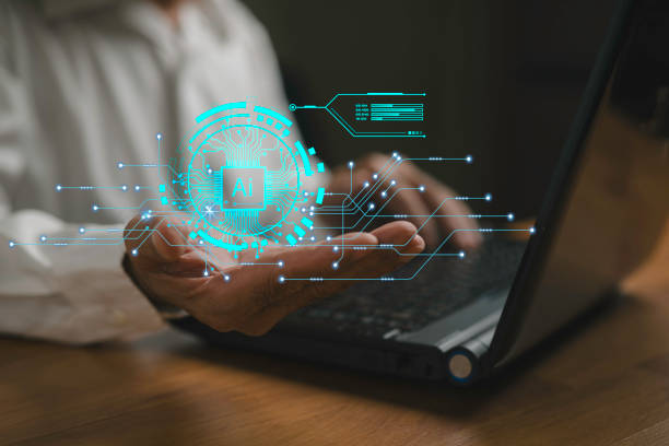 istock Businessman using laptop computer and holding AI icon showing advanced technology work with Artificial intelligence. Artificial intelligence development concept. 2184655631