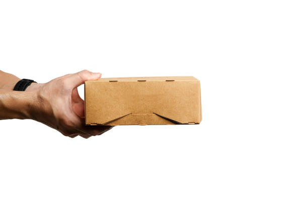 istock Hand holding a brown cardboard box with a recycling sign on a white background.Ideas for choosing recycled boxes,cardboard box for delivery on a white background 2184657244