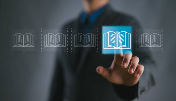 istock E-library concept. Person use smartphone and hand touch with virtual Ebook icons for electronic books online, knowledge base on internet, digital library or e-library. 2184657743