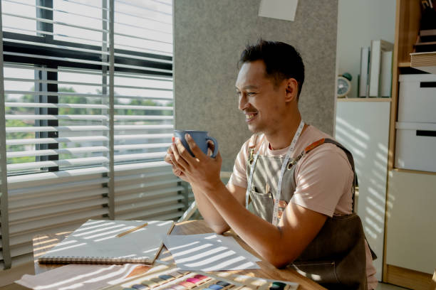 istock a fashion designer dis taking a break in his sewing studio after working all morning, a tailor is spending his free time in his workshop, which is filled with design and sewing equipment 2184660551