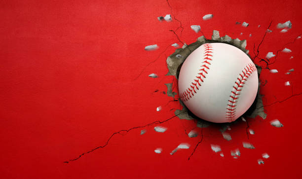 istock Baseball breaks through red concrete wall concept of power, strength. 2184666238