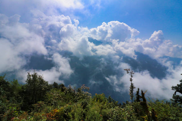 Early morning scene of clouds rising from the deep valleys of lower himalayas near Pangom village,on route to the Base camp of Mera Peak,a 6476 meter high peak in the Khumbu Himalayas,Nepal