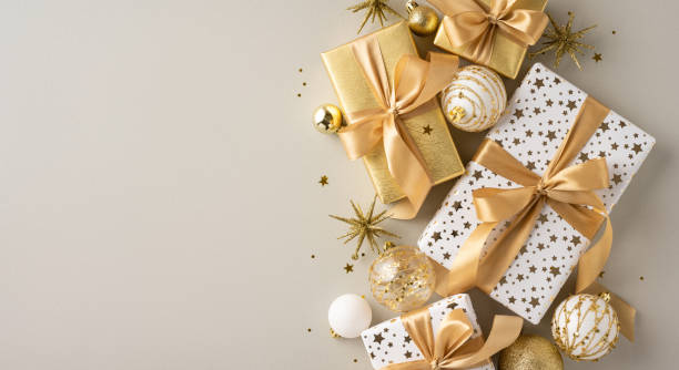 istock Luxurious Christmas gifts in gold and white wrapping with festive decorations create an elegant and celebratory holiday atmosphere 2184681004