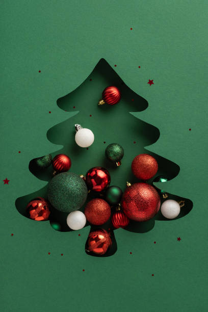 istock A vertical creative Christmas tree silhouette filled with colorful ornaments including red, green, and white balls, capturing the festive spirit and holiday joy 2184681039