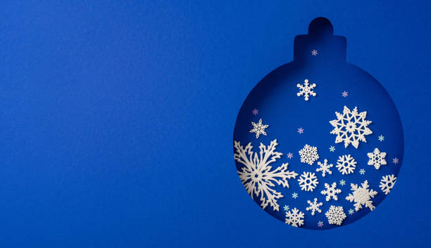 istock A blue Christmas ornament featuring detailed snowflake cutouts on a vibrant background, exemplifying holiday spirit and creativity. Perfect for festive decorations and celebrating the season's joy 2184681051