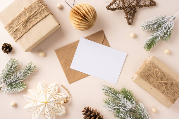 istock Top view of a rustic Christmas card setup with natural decorations, pine branches, and wrapped gifts emphasizing a festive and organic theme 2184681070