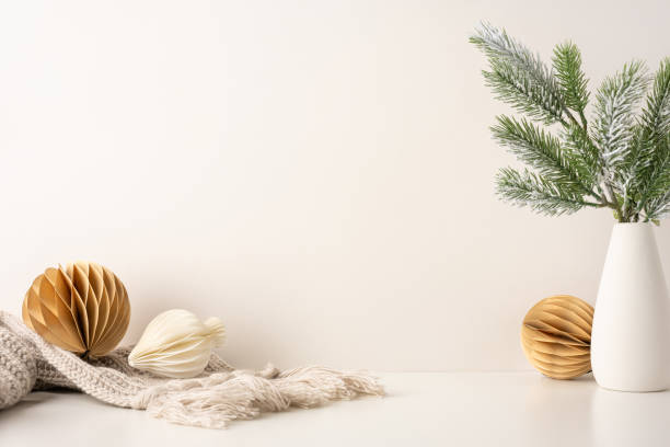 istock Minimalist side view Scandinavian Christmas theme featuring pine branches in a vase and natural ornaments. Cozy and elegant winter decoration with a neutral palette emphasizing simplicity and warmth 2184681120