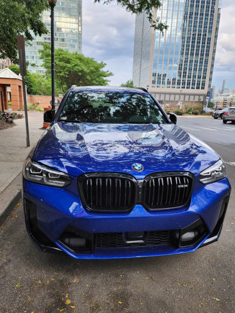 New York City, USA - June 09, 2023: BMW X3 M COMPETITION SUV blue car front view parked.