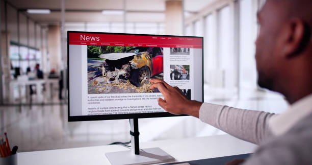istock Watching Online News Article On Mobile Phone And Laptop 2184686687