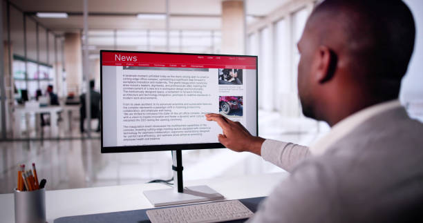 Watching Online News Article On Mobile Phone And Laptop