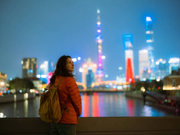istock Woman looking at Shanghai cityscape at night 2184686757