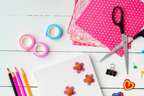 istock Crafting a colorful workspace with decorations, stationery, and artistic tools on a clean wooden surface 2184688290