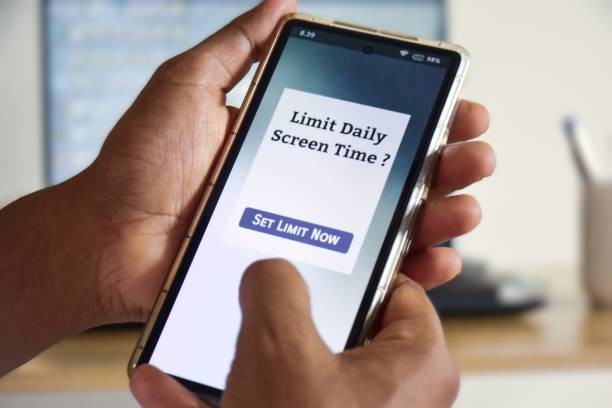 istock Man trying to set screen time limit usage on his smartphone. Digital wellbeing concept. 2184688505