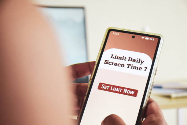Man trying to set screen time limit usage on his smartphone. Digital wellbeing concept.