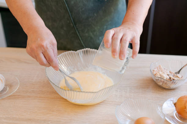 istock Woman is making a dessert on a wooden table 2184690695