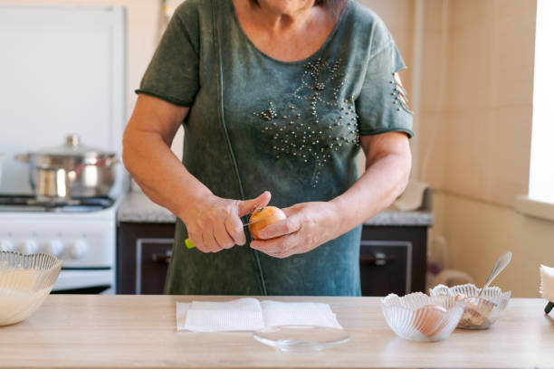 istock Woman is cutting a carrot on a table 2184690699