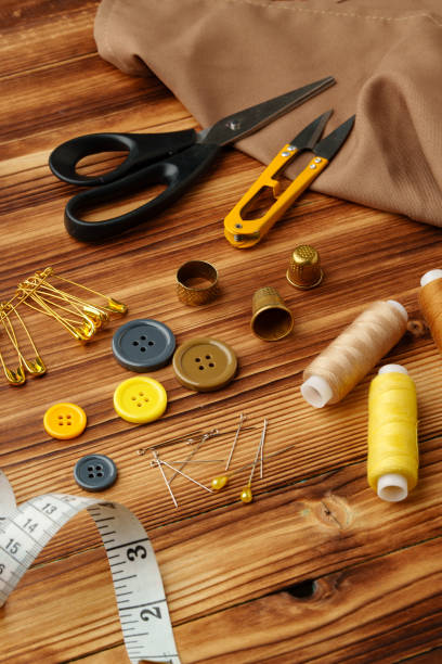 istock Crafting tools and materials arranged on a wooden table ready for sewing and creative projects 2184691013