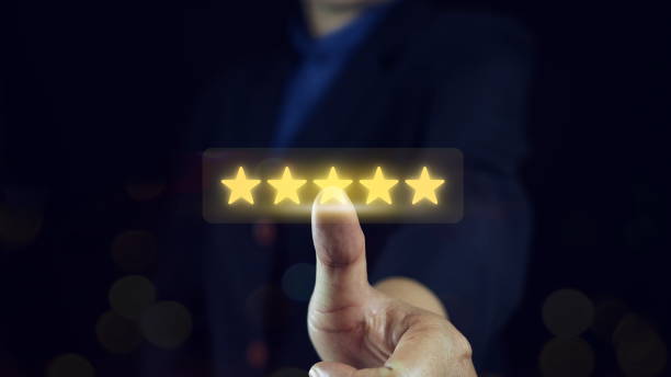 istock Customer service experience and business satisfaction survey. Customer review good feedback, Close Up Man hand using smartphone with popup five-star icon for feedback review satisfaction service. 2184694517