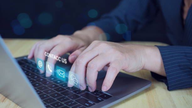 istock Contact us or Customer support hotline people connect. Businessman use pen and touching on virtual screen contact icons ( email,smartphone, live chat).Contact us connection concept 2184694518