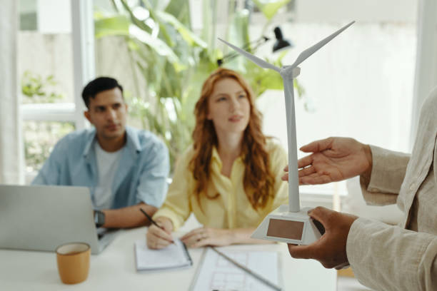 istock Engineer Showing The Work Of Windmill To Colleagues 2184695968