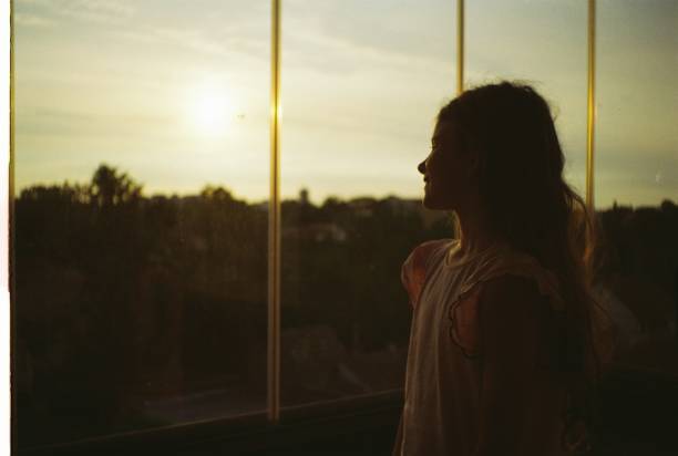 istock Beautiful girl watching sunset 2184696091