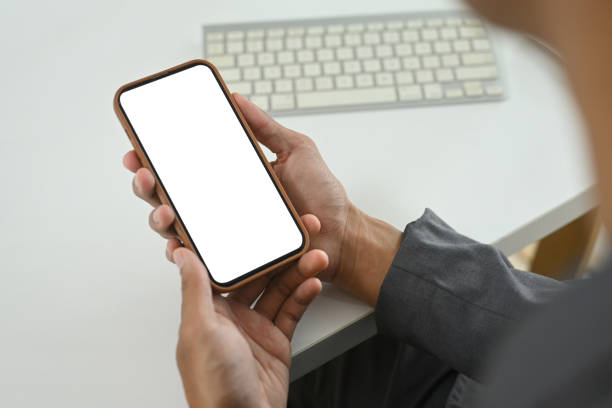 istock Close up of young businessman using smartphone in office workspace 2184696460