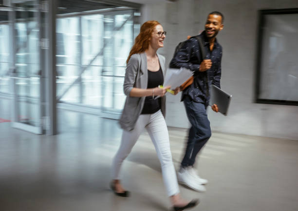 istock Dynamic Business Duo Quickening Pace in Office Corridor 2184697735