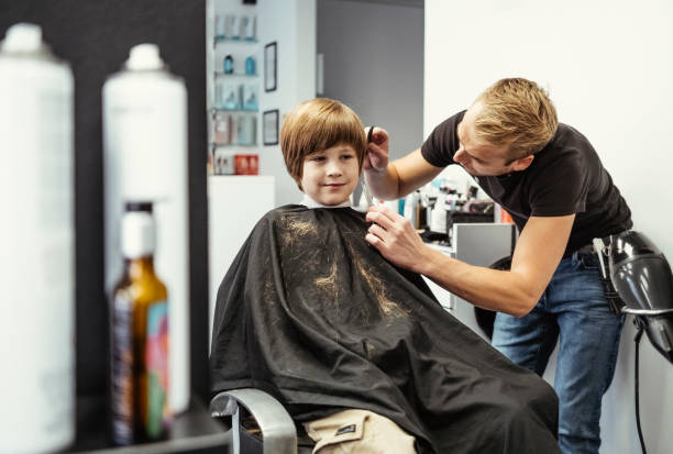 istock Professional Haircutting Session for Young Boy at Modern Salon 2184697896
