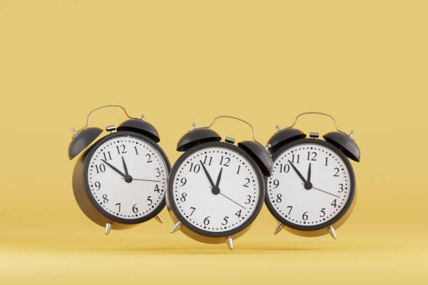 istock Black Friday Concept, Black Alarm Clocks on Yellow Background 2184699067
