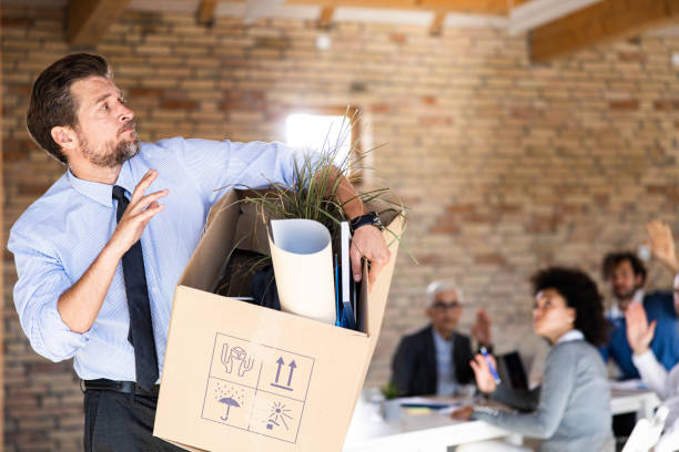 istock Depressed businessman leaving the office after being fired. 2184699327